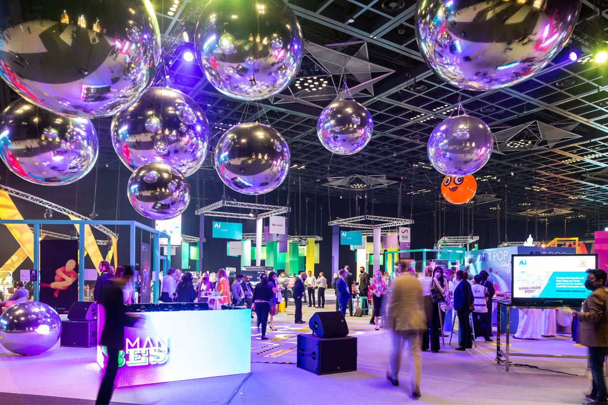 Visitors moving through a brightly lit exhibition hall